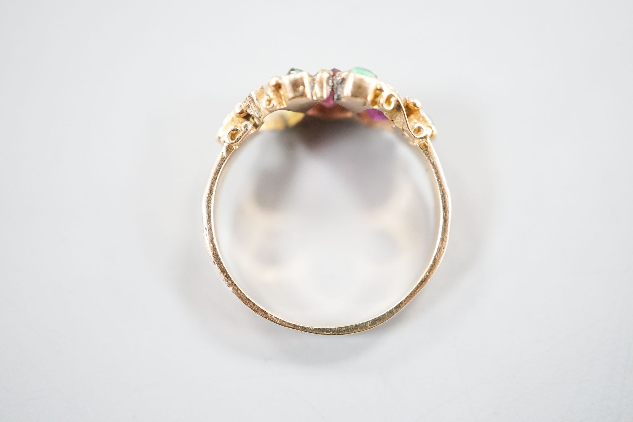 A late Victorian 15ct gold, garnet and emerald set dress ring(stone missing & stone replacement?), size L, gross 2.2grams.
